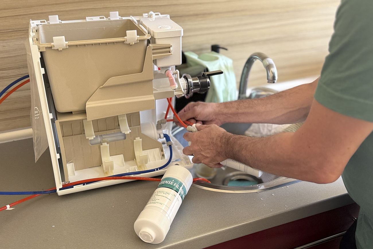 Technician repairing a kitchen appliance during service at the workshop